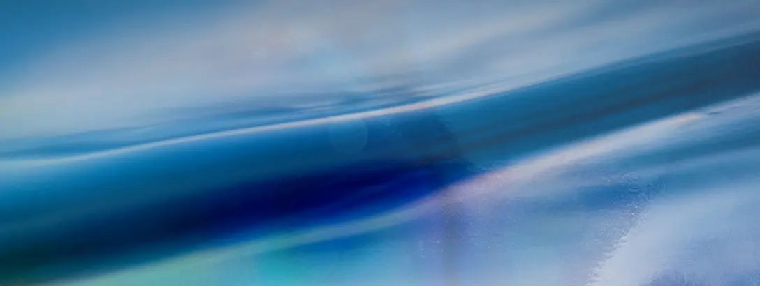 A blurred abstract image filled with soothing shades of blue and turquoise, evoking a sense of calm. Soft gradients sweep across the surface, suggesting movement and fluidity.