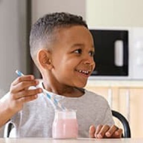 Kid enjoying a smoothie